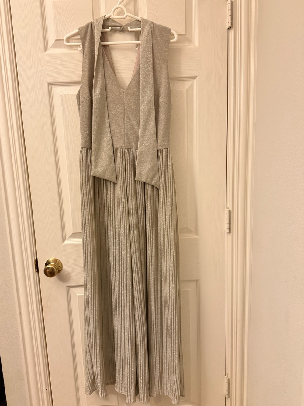 Adelyn Rae Silver Metallic V-Neck Sleeveless Jumpsuit with Flowing Pleated Legs